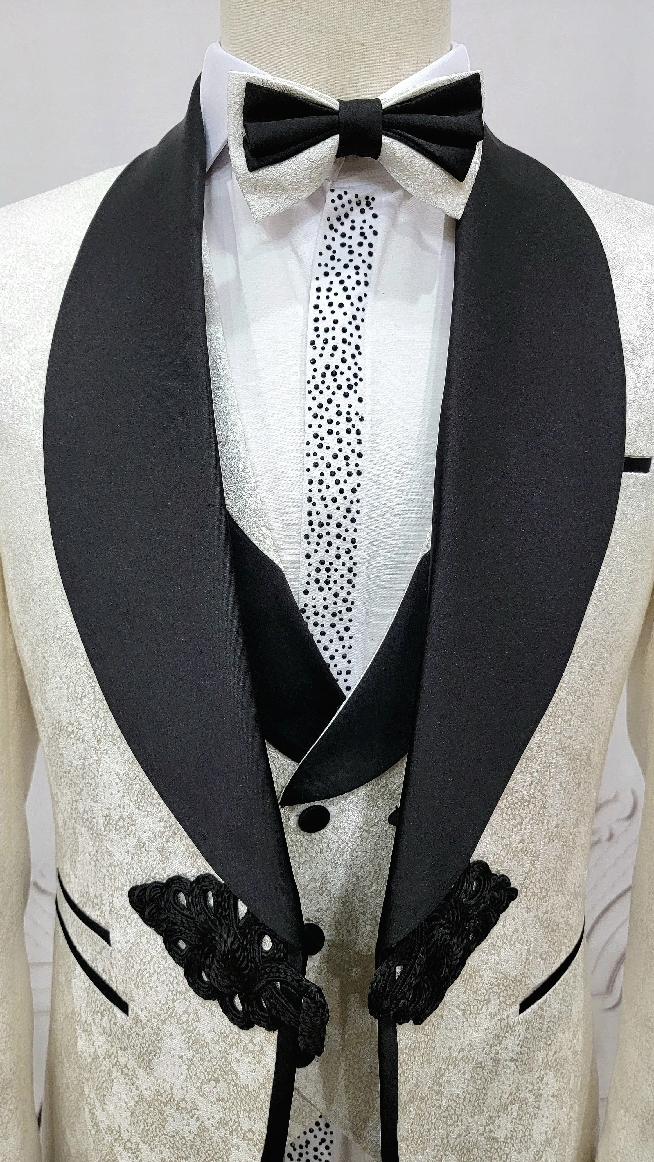 Three Piece Tuxedo Suit with Contrasting Black Lapel, matching bow tie and Black Pants. white knot
