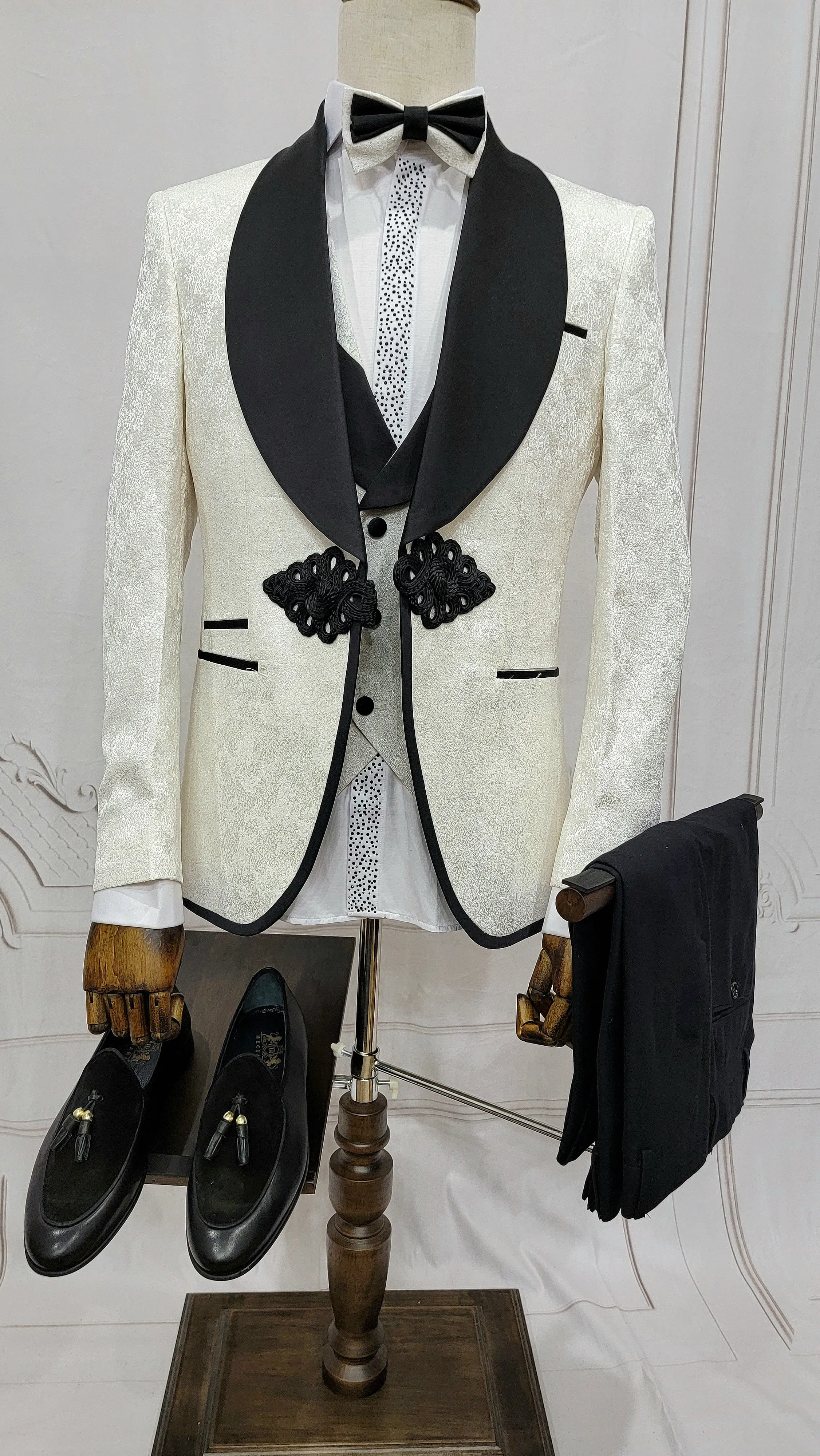 Three Piece Tuxedo Suit with Contrasting Black Lapel, matching bow tie and Black Pants. white knot
