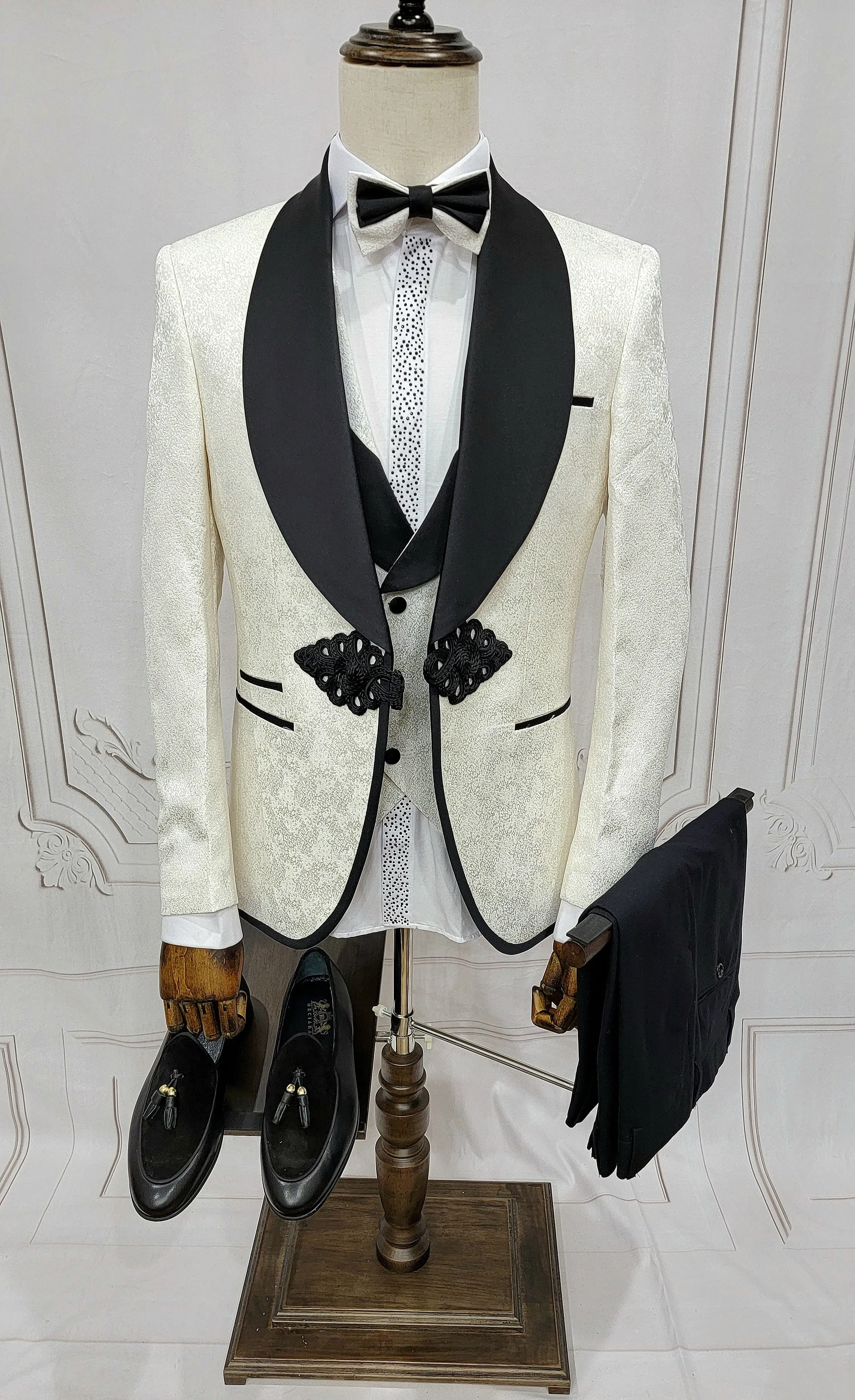 Three Piece Tuxedo Suit with Contrasting Black Lapel, matching bow tie and Black Pants. white knot