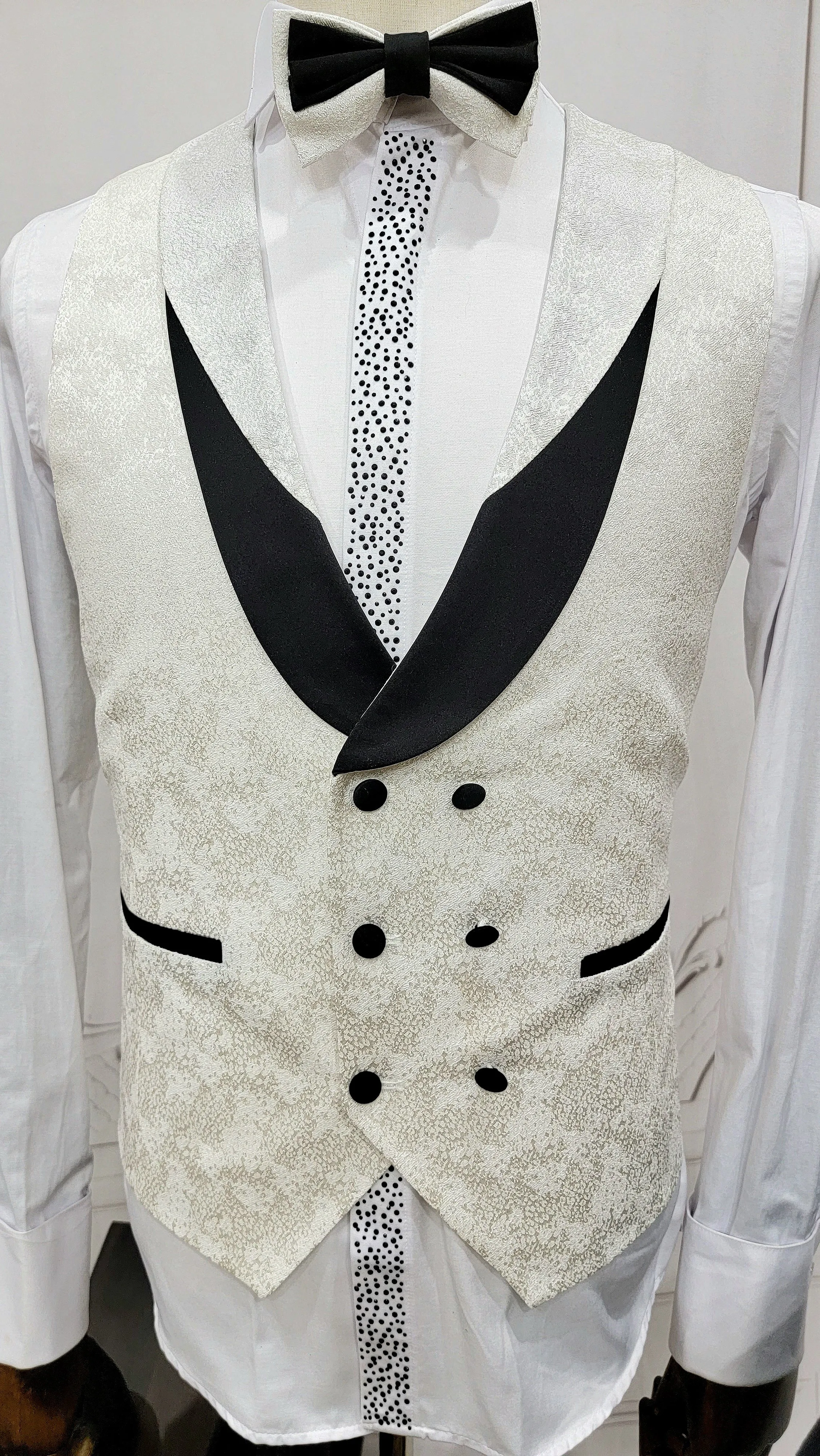 Three Piece Tuxedo Suit with Contrasting Black Lapel, matching bow tie and Black Pants. white knot