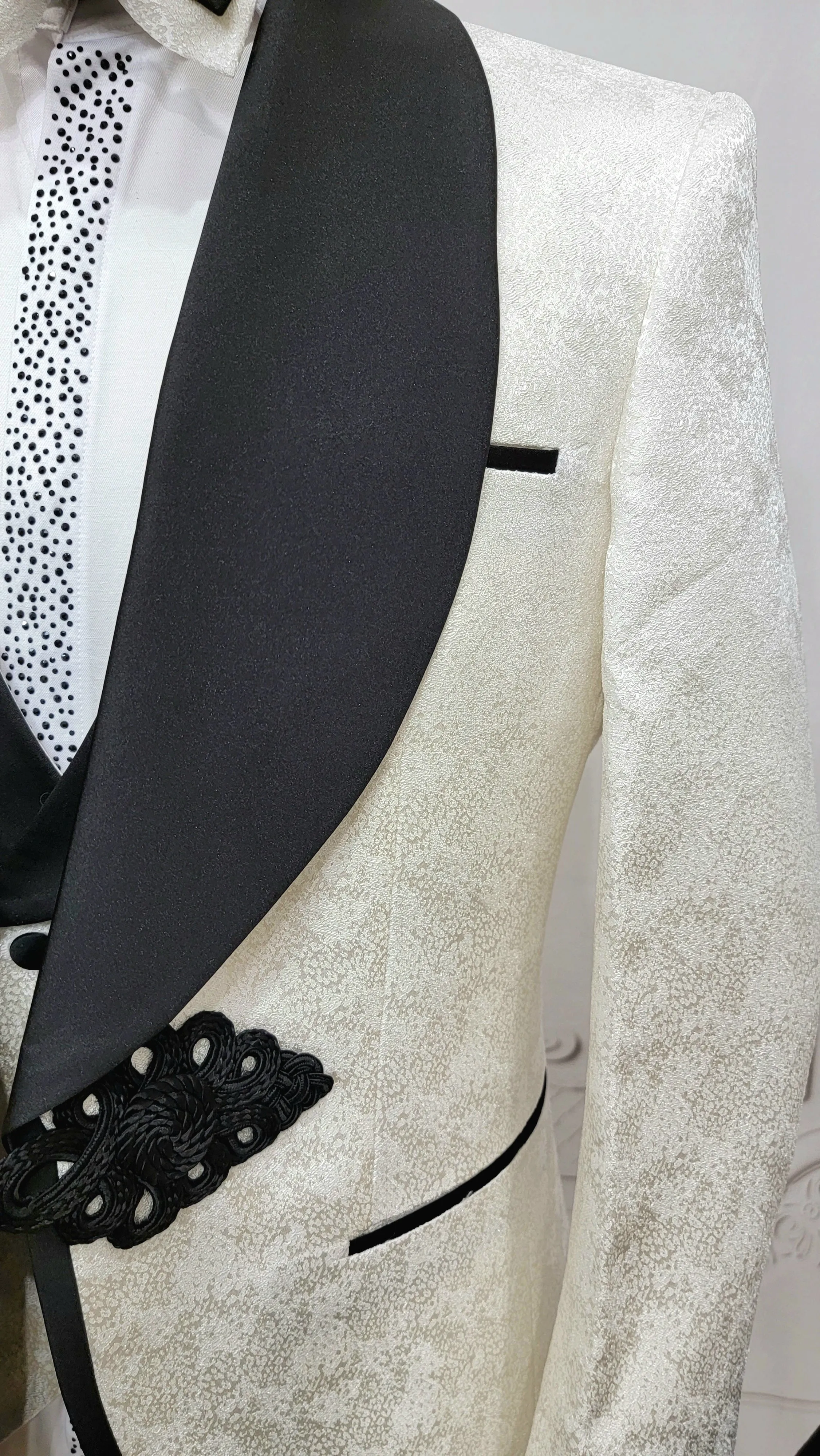 Three Piece Tuxedo Suit with Contrasting Black Lapel, matching bow tie and Black Pants. white knot