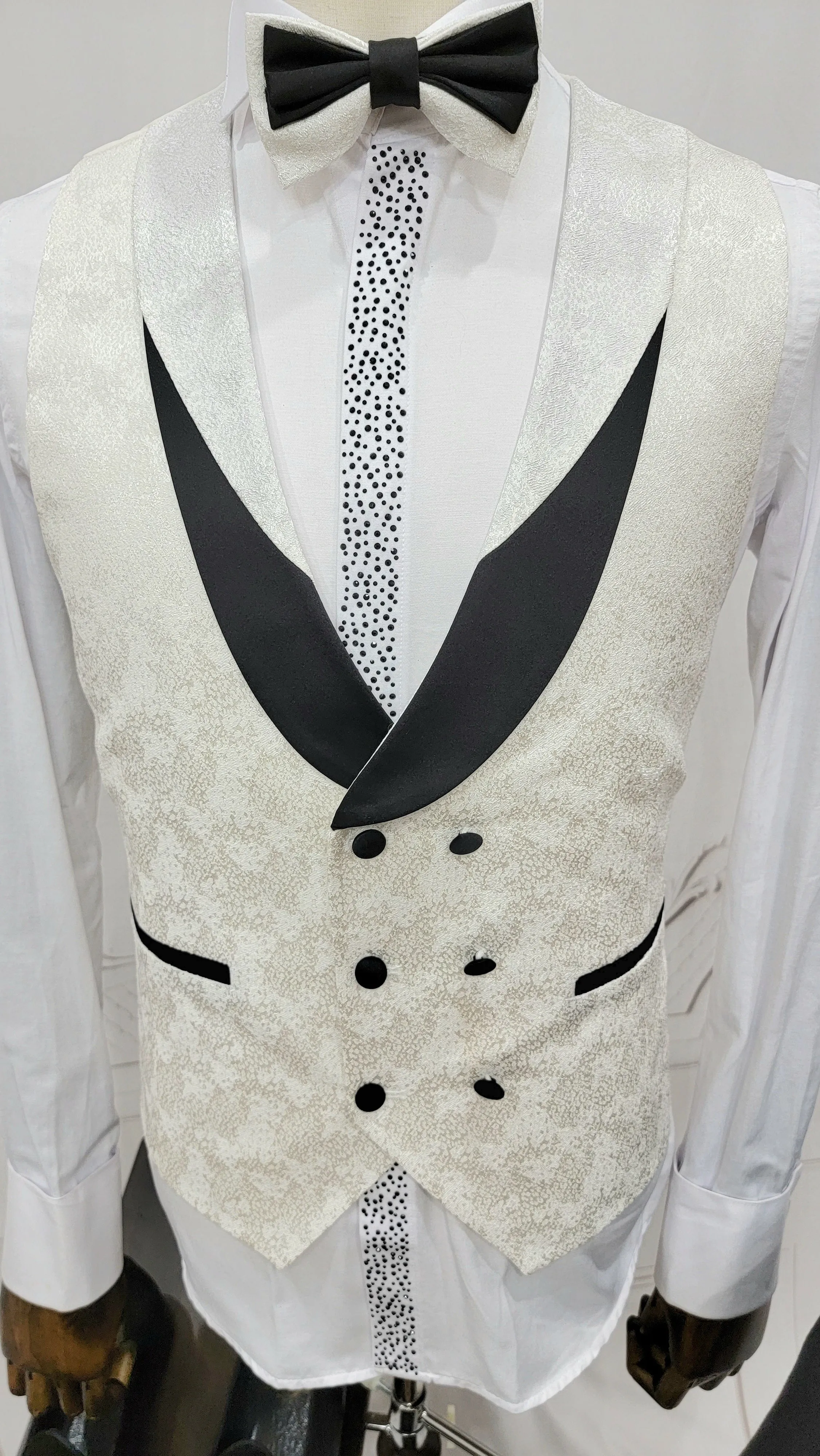 Three Piece Tuxedo Suit with Contrasting Black Lapel, matching bow tie and Black Pants. white knot