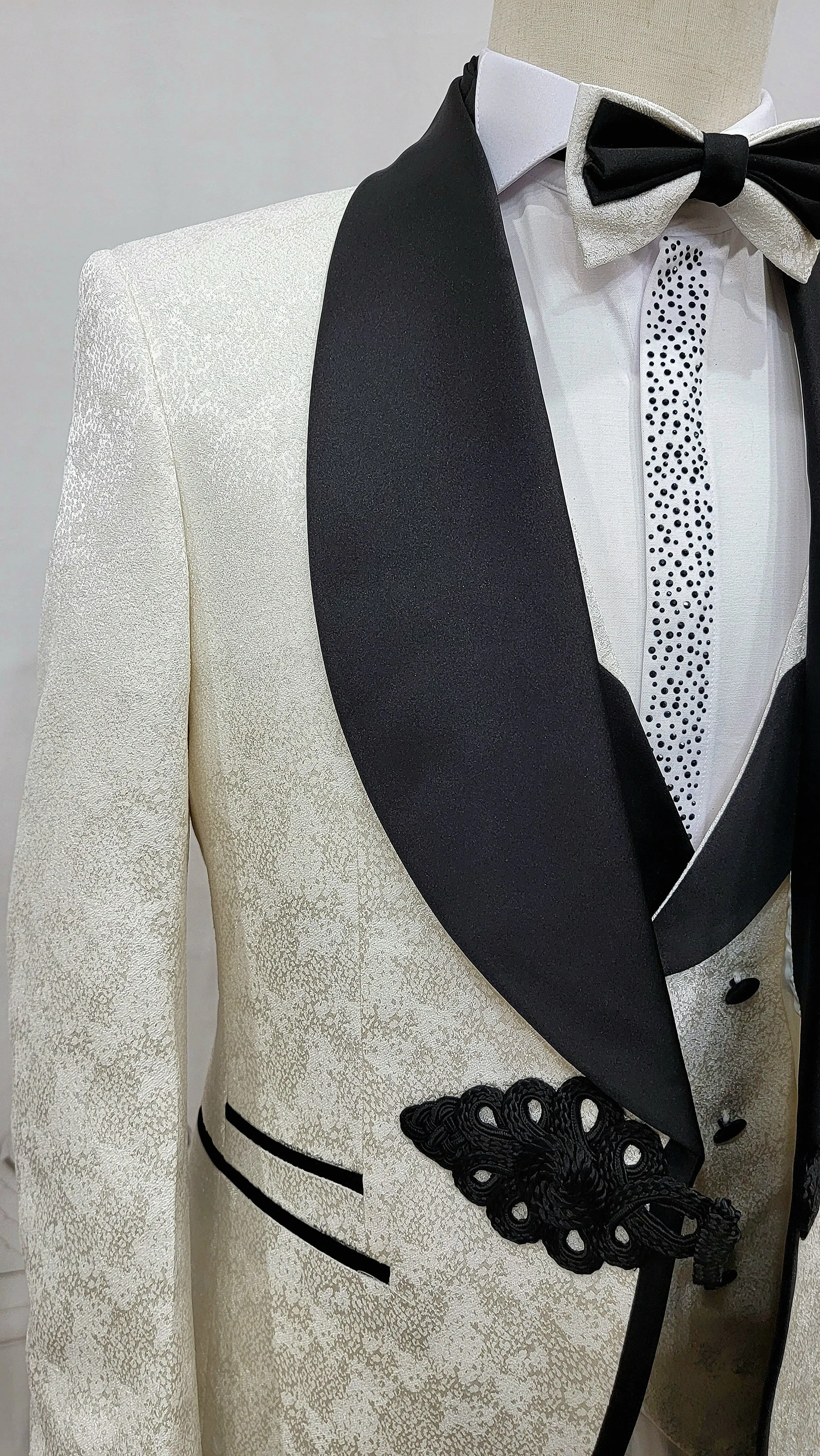 Three Piece Tuxedo Suit with Contrasting Black Lapel, matching bow tie and Black Pants. white knot