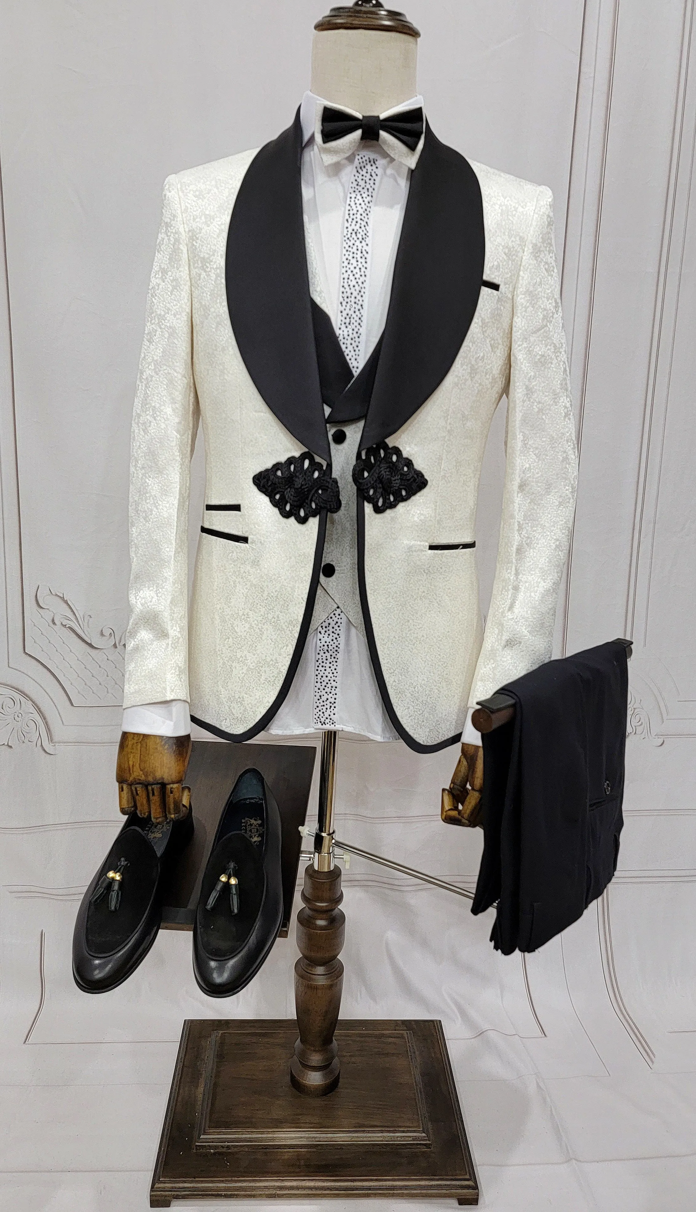 Three Piece Tuxedo Suit with Contrasting Black Lapel, matching bow tie and Black Pants. white knot